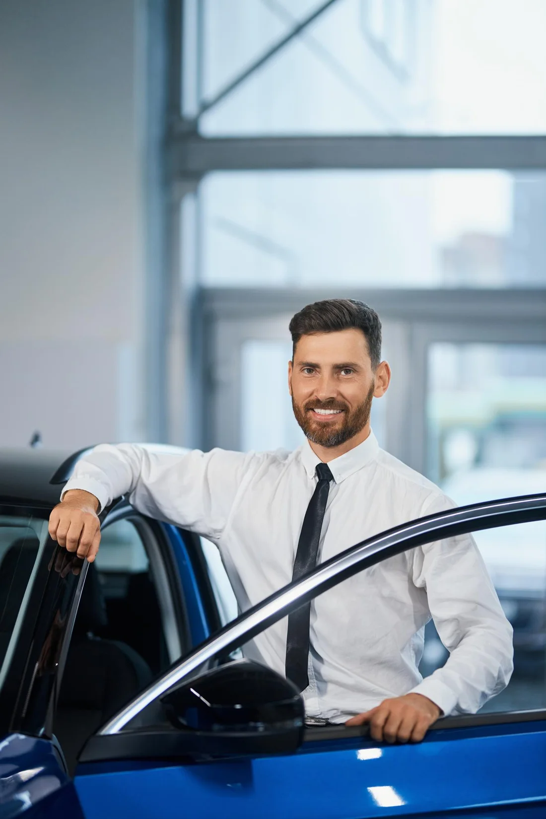 Driver standing beside a car